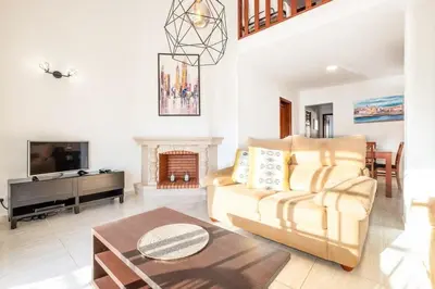a living room with a couch and a fireplace at Apartment Arrifes in Albufeira