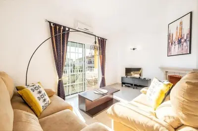a living room with a couch and a table at Apartment Arrifes in Albufeira