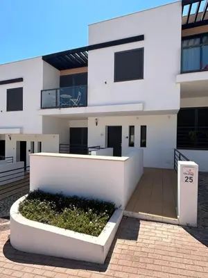 a white building with a courtyard in front of it at Three Bedroom Sea View Townhouse Villa in Albufeira