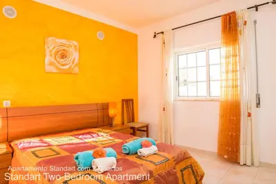 a bedroom with a bed with two stuffed animals on it at Akisol Albufeira Ocean II in Albufeira