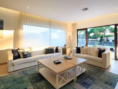 a living room with two couches and a coffee table at Contemporary Vilamoura Villa Stunning Open Plan Design Villa Azure Elegance in Quarteira