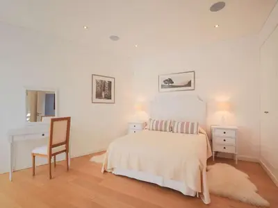 a bedroom with a bed and a desk and a chair at Contemporary Vilamoura Villa Stunning Open Plan Design Villa Azure Elegance in Quarteira