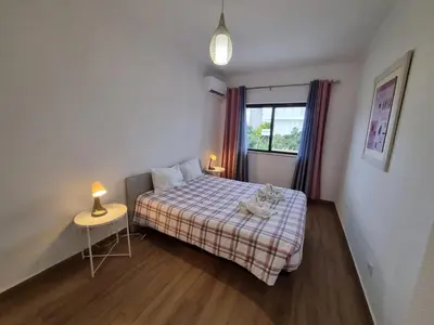 a bedroom with a bed with a cat sitting on it at The Albufeira Concierge - Prime Beach Center L3 in Albufeira