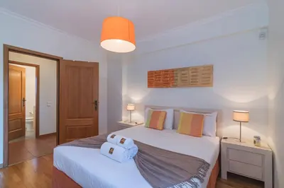 a bedroom with two beds and a light at Vilamoura - VILLA VINTE in Vilamoura