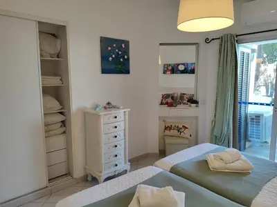 a bedroom with two beds and a dresser at Albufeira Balaia Golf Vilage 4 With Pool by Homing in Albufeira