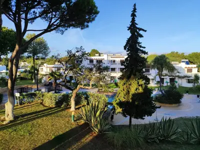 a view of a park with trees and buildings at Albufeira Balaia Golf Vilage 4 With Pool by Homing in Albufeira