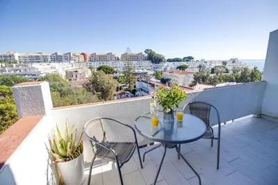 a table and chairs on a balcony with a view at Lovely 3BD 150m Beach Ocean View AC Wi-Fi Balcony in Albufeira