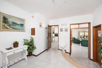 a corridor of a hospital room with a table and plants at Villa Cavaco in Vilamoura