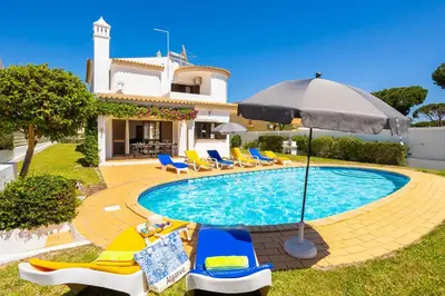 a large swimming pool in a yard at Villa Cavaco in Vilamoura