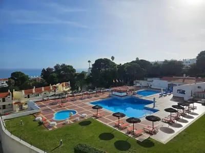 an overhead view of a swimming pool with umbrellas at Lagoon Bleue in Albufeira