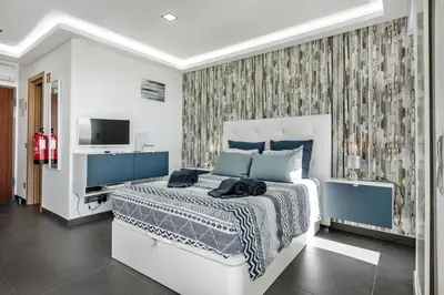 a bedroom with a bed and a tv in it at Lagoon Bleue in Albufeira