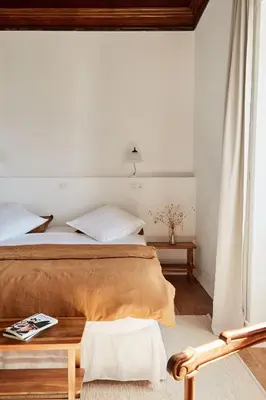 a bedroom with a bed and a table at Solar do Bisavô in Bordeira