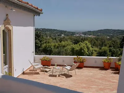 a patio with chairs and a table on a house at Solar do Bisavô in Bordeira