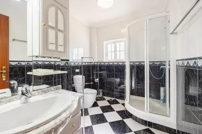 a bathroom with a sink and a shower and a toilet at Villa Marlene in Guia