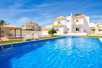 a white room with two beds and a window at Villa Marlene in Guia