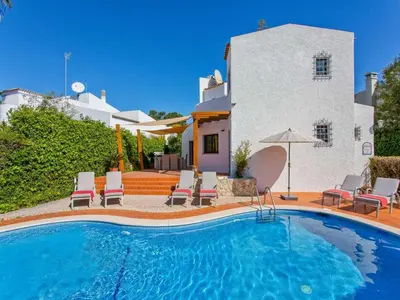 a swimming pool in front of a house at Charming Vilamoura Villa Short Walk To Marina Villa O Clube 3 Bedrooms in Quarteira