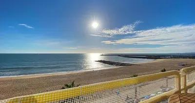 a view of the ocean from a balcony of a beach at Quarteira Frente Praia II by HomeSlow Rentals in Quarteira