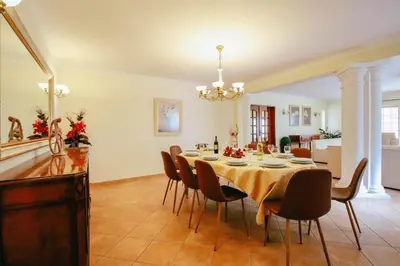 a dining room with a table and chairs at Villa Punta Cana by Algarve Vacation in Albufeira