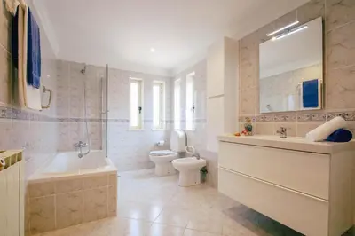 a bathroom with a sink and a tub and a toilet at Villa Punta Cana by Algarve Vacation in Albufeira