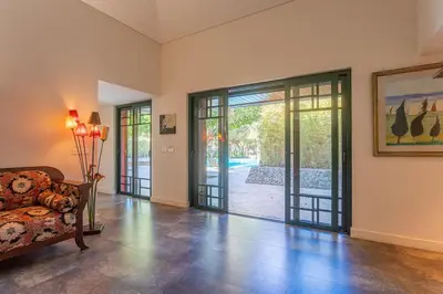 an empty living room with a couch and sliding glass doors at Villa Adelaide in Quarteira
