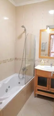 a bathroom with a bath tub and a sink at Encosta Da Orada in Albufeira