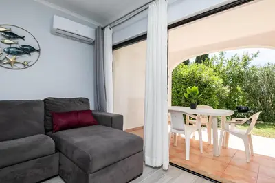 a living room with a couch and a table at Apartment in São Rafael Albufeira Beach Resort in Albufeira