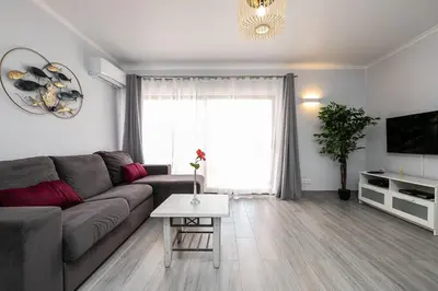 a living room with a couch and a tv at Apartment in São Rafael Albufeira Beach Resort in Albufeira