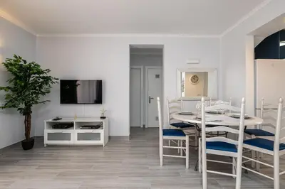 a kitchen and dining room with a table and chairs at Apartment in São Rafael Albufeira Beach Resort in Albufeira
