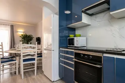 a kitchen with blue and white walls and a table at Apartment in São Rafael Albufeira Beach Resort in Albufeira