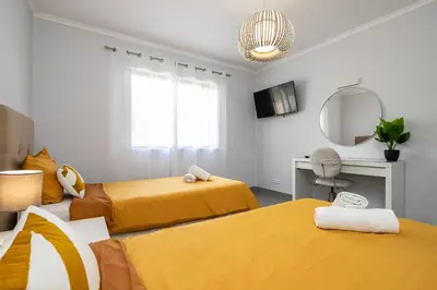 a bedroom with two beds and a desk and a mirror at Apartment in São Rafael Albufeira Beach Resort in Albufeira