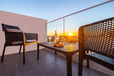 a balcony with a table and two chairs and a view at Townhouse Varadero by Algarve Vacation in Albufeira