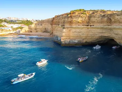 a group of boats in the water near a cave at Townhouse Varadero by Algarve Vacation in Albufeira