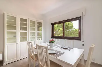 a white dining room with a white table and chairs at Vilamoura M.M. Sunrise T2 in Vilamoura