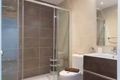 a bathroom with a shower and a toilet and a sink at Vilamoura M.M. Sunrise T2 in Vilamoura