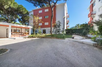 an empty parking lot in front of a building at Vilamoura M.M. Sunrise T2 in Vilamoura
