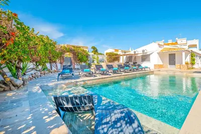 a swimming pool with lounge chairs and a swimming pool at Villa Shangri-La by Algarve Vacation in Albufeira