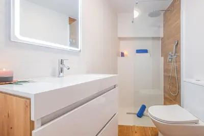 a white bathroom with a sink and a toilet at Villa Shangri-La by Algarve Vacation in Albufeira