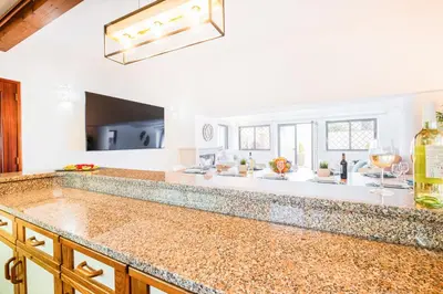 a kitchen with a counter top with wine glasses at Villa Shangri-La by Algarve Vacation in Albufeira