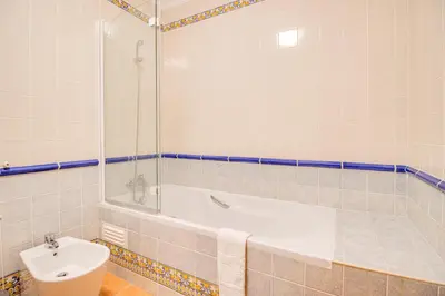 a bathroom with a tub and a toilet and a sink at Villa Periquito 2BD Pool Fast WiFi AC Garden in Albufeira