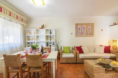 a living room with a table and a couch at Vilamoura M.M. Holidays T2 in Vilamoura