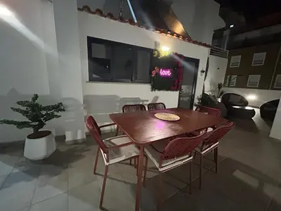 a dining room with a wooden table and chairs at Boutique Style Town House in Albufeira