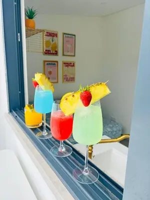 three cocktails sitting on a counter in a room at Boutique Style Town House in Albufeira