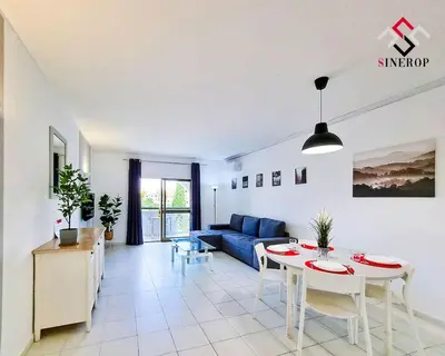 a living room with a blue couch and a table at Apartamento T1 - Valmangude in Albufeira