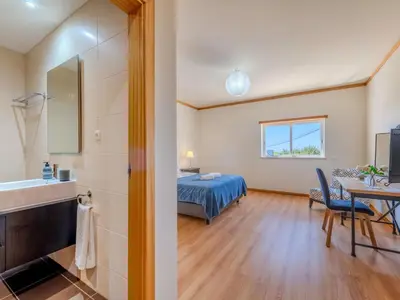 a bedroom with a large bed and two lamps at Apartment Aguia M T2 - VIP Properties by Interhome in Albufeira