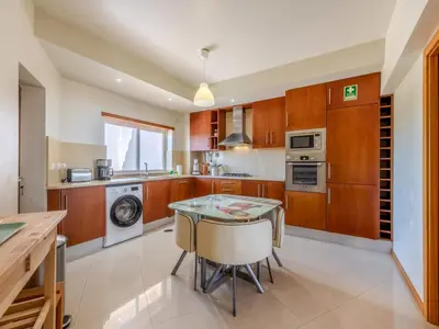 a living room with a purple couch and a table at Apartment Aguia M T2 - VIP Properties by Interhome in Albufeira