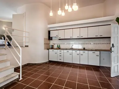 a living room with a bar with stools at Villa Aladdin - VIP Properties by Interhome in Albufeira