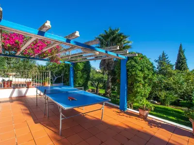 a white table with an umbrella and a pool at Villa Fernandes by Interhome in Albufeira
