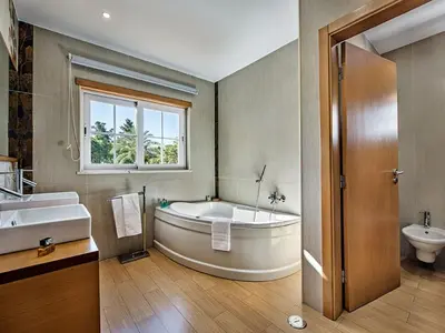 a bathroom with a tub and a sink and a toilet at Holiday Home Demi - VIP Properties by Interhome in Albufeira
