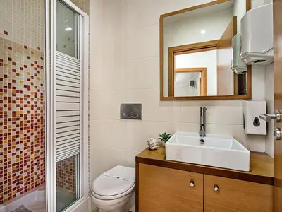 a bathroom with a sink and a toilet and a mirror at Holiday Home Demi - VIP Properties by Interhome in Albufeira
