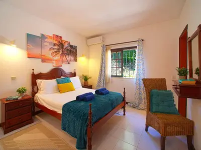a bedroom with a large bed with blue pillows at Villa Maria by Interhome in Albufeira